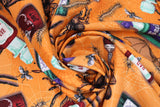 Swirled swatch halloween printed fabric in Potions, Bats and Bugs (potion bottles, centipedes, large spiders, on orange)