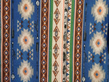 Square swatch southwest print fabric (striped pattern with geometric shapes, arrows, and feathers with a blue/brown/green/beige colourway)