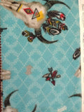 Square swatch southwest print fabric (bright blue/aqua fabric with subtle white cross pattern and tossed southwest emblems animal skull, feathers, dream catchers, turtles all in a white/aqua/yellow colourway)