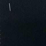 Swatch of heavy blue-ish black denim (with staple in the upper left corner)