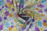 Swirled swatch natural layered fabric (off white fabric with tossed layered wildflower floral in yellow, blue, purple, orange floral heads and green stems/leaves)
