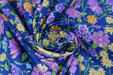 Swirled swatch navy layered fabric (navy fabric with tossed layered wildflower floral in yellow, blue, purple, orange floral heads and green stems/leaves)