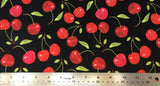 Flat swatch cartoon red and green cherry printed fabric on black