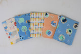 Fanned 5pc precuts in style "Farm Friends" (cream with basic cartoon/drawn style farm animals, same as cream fabric but in blue, cream fabric with orange and yellow carrots allover in neat lines/stripes, peach with circular farm animal badges, blue with circular farm animal badges)