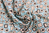 Swirled swatch Gallery Wall fabric (light blue striped fabric with packed picture frames allover in square and oval/circular shapes with human and insect silhouettes inside)