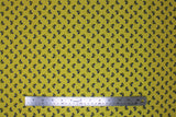 Flat swatch Bows fabric (pale mustard fabric with tossed black bows with white accents)