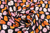 Swirled swatch Cute Gords fabric (black fabric with neat rows of halloween guords with smiley faces)