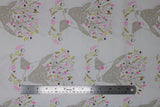 Flat swatch Portrait fabric (white fabric with pale brown drawn style deer with rosy cheeks and floral/greenery underneath and in antlers in the following colourway: pink, rust, yellow, black/navy)