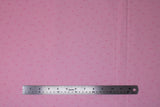 Flat swatch Scattered Triangles fabric (pink fabric with dark pink hollow triangle outlines scattered allover)