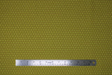 Flat swatch Daisy Dot fabric (pale olive coloured fabric with small yellow daisies in dark olive circles allover)