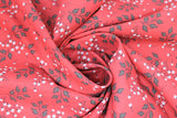 Swirled swatch Sprigs fabric (deep watermelon pink fabric with tossed leafy sprigs in grey and tossed floral sprigs in white with grey stems)