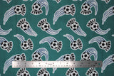 Flat soccer ball printed fabric swatch in green (medium pale green fabric with black/white soccer balls with sport swoosh lines in blue and "GOAL!" text in black)