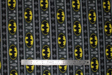 Flat swatch fair aisle fabric (batman christmas sweater look fabric with black and dark green sweater look stripes and pixelated/knit look yellow and black batman logo)