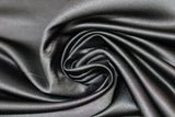 Swirled swatch black satin fabric