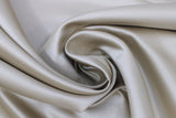 Swirled swatch champagne satin fabric