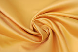 Swirled swatch butter yellow satin fabric