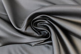Swirled swatch charcoal grey satin fabric