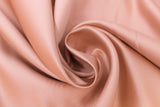 Swirled swatch rose gold satin fabric