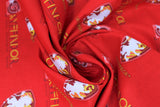 Swirled swatch licensed Harry Potter printed fabric in Gryffindor Traits Scatter (crest and text tiled on red)