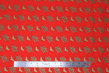 Flat swatch licensed DC Comics printed fabric in Wonder Woman Retro (small tiled gold logo and Wonder Woman text on red)