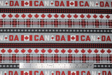 Flat swatch gray multi stripe 1 fabric ("Canada" text stripes in red and white lettering on grey background, black/red buffalo stripes, grey with faint polka dots and red leaves stripe, red plaid stripe, grey leaves on dark grey stripe, repeated pattern)