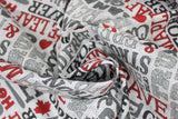 Swirled swatch light grey words fabric (light grey fabric with Canada related text allover in red, black, light and dark grey "Brave" "Home" "Maple Leaf" etc. with small red hearts and leaves)