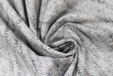 Swirled swatch light grey knit fabric (light grey knit look fabric with subtle black accents)