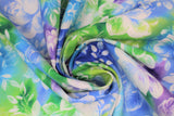 Swirled swatch watercolour floral fabric (light blue, blue, purple, light and dark green marbled/watercolour look fabric with large white floral heads and leaves pattern)