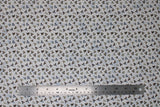 Flat swatch shark teeth fabric (white fabric with small lines of white, off white, blue and grey shark teeth)