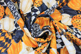 Swirled swatch packed pumpkins fabric (black fabric with medium sized tossed/collaged pumpkins allover in orange, off white, black, and various orange/black or orange/off white combos including dots, checkers, etc.)