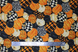 Flat swatch packed pumpkins fabric (black fabric with medium sized tossed/collaged pumpkins allover in orange, off white, black, and various orange/black or orange/off white combos including dots, checkers, etc.)