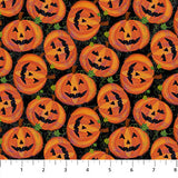 Flat swatch Pumpkin Toss fabric (black fabric with tossed jack-o-lanterns allover with green leaves)