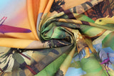 Swirled swatch dinosaur printed fabrics in volcano (cartoon outdoor dinosaur scene volcanos and rocks with orange sky and walking dinosaurs and trees)