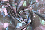 Swirled swatch assorted floral printed fabric in plum (dark purple/black fabric with watercolour look horizontal abstract lines pattern in various purple and blue shades)