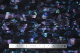 Flat swatch assorted floral printed fabric in plum (dark purple/black fabric with watercolour look horizontal abstract lines pattern in various purple and blue shades)