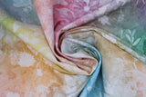 Swirled swatch assorted floral printed fabric in pastel (pastel rainbow marbled fabric with white floral silhouettes and butterflies tossed allover)