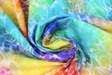 Swirled swatch radical rainbow fabric in water (bright rainbow watercoloured fabric with white wavy water texture/lines)