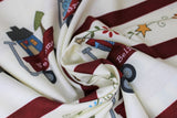Swirled swatch stripes fabric (off white fabric with lines of cartoon red wagons with different holiday elements within and white labels accordingly "Brrrr" on a wagon with a snowman inside, etc.)