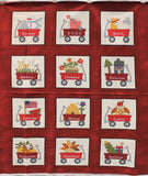 Full Panel (46" x 36") swatch (red marbled look rectangular panel with 12 white squares showcasing 12 cartoon red wagons with different holiday/themed elements within and applicable white labels on wagon "XOXO" on wagon with heart)