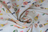 Swirled swatch prosecco pop fabric (white fabric with tossed cartoon bottles of prosecco in various colours pink, orange, green, yellow, blue, and tossed glasses of yellow champagne)