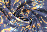 Swirled swatch Dino Skeletons fabric (black fabric with multi-coloured dinosaur skeletons allover in various shapes and sizes)