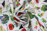 Swirled swatch Homegrown Toss fabric (white fabric with tossed drawn homegrown emblems and text: seeds, veggies, flowers, crows, etc.)