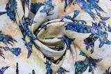 Swirled swatch Witches fabric (neutral marbled look fabric with tossed blue witch and broom silhouettes allover)