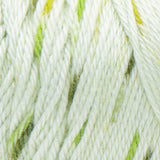 Swatch of Caron Simply Soft Speckle yarn in shade chlorophyll (white/palest green yarn with light and dark green speckles)