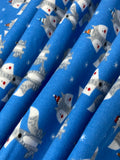 Swirled swatch winter themed flannel in Winter fox (grey cartoon foxes with hats on medium blue)