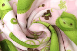 Swirled swatch FLC fleece print in Sweet Pea in Pink (white and brown flowers, happy pea pods on pink)