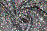 Swirled swatch tropical fabric in colourful specks black (black fabric with tiny blue, yellow, pink specks)