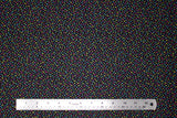 Flat swatch tropical fabric in colourful specks black (black fabric with tiny blue, yellow, pink specks)