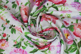 Swirled swatch flower printed fabric in white (pink/purple flowers and stems/leaves on white)