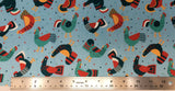 Flat swatch cartoon chicken printed fabric in blue (light blue fabric with tossed cartoon chickens in navy, red, blue, yellow colourway and tossed tiny triangles in navy, blue and red)